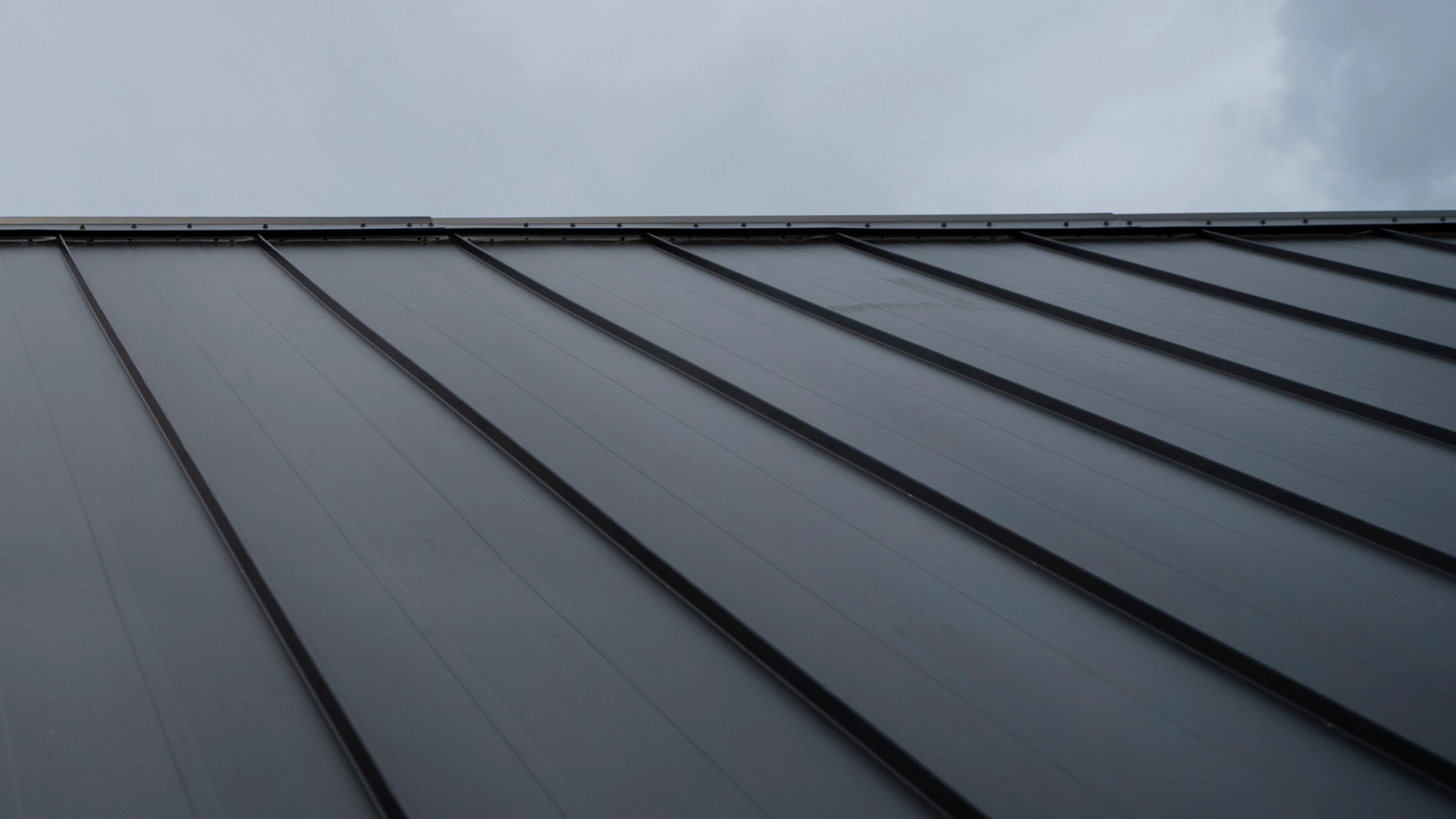 black roofing of a house with the sky at the back